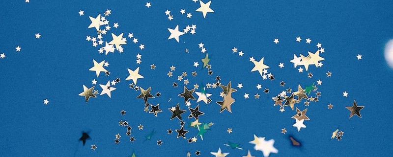 flock of birds flying under blue sky during daytime