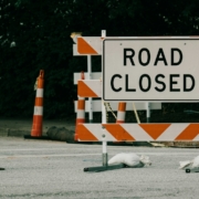 a road sign with orange cones