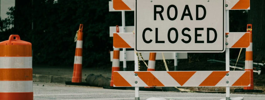 a road sign with orange cones