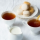 two cups of coffee beside the macaroons on plate